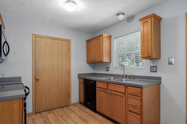1651 S Mahn Ct, Springfield, MO 65802 - kitchen featuring black dishwasher, light wood finished floors, dark countertops, brown cabinetry, and stove