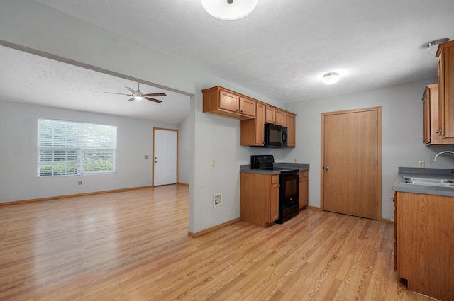 1651 S Mahn Ct, Springfield, MO 65802 - kitchen with black appliances, light wood finished floors, brown cabinetry, a ceiling fan, and open floor plan