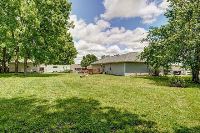 1651 S Mahn Ct, Springfield, MO 65802 - view of green lawn with a deck