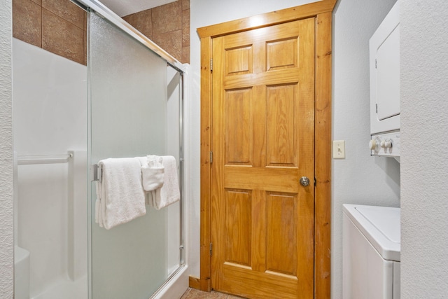 76 Bells Ave Unit 98, Branson West, MO 65737 - full bathroom featuring stacked washer / drying machine and a shower with shower door