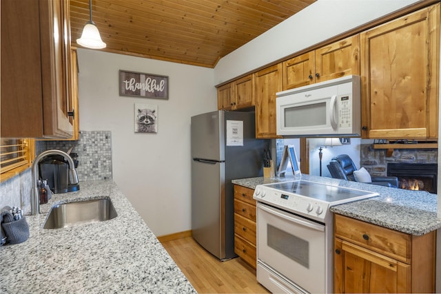 76 Bells Ave Unit 98, Branson West, MO 65737 - kitchen featuring white appliances, brown cabinetry, tasteful backsplash, light wood-style flooring, and wood ceiling