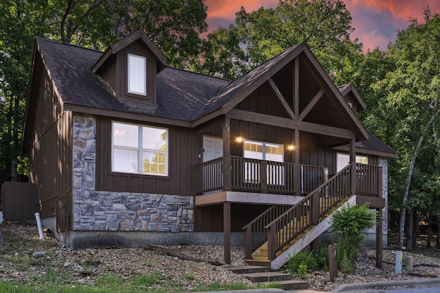 76 Bells Ave Unit 98, Branson West, MO 65737 - rear view of property featuring stone siding, a shingled roof, stairway, and board and batten siding