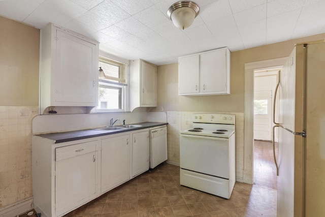 1123 W Hovey St, Springfield, MO 65802 - kitchen with white appliances, white cabinetry, dark countertops, tile walls, and tile patterned flooring