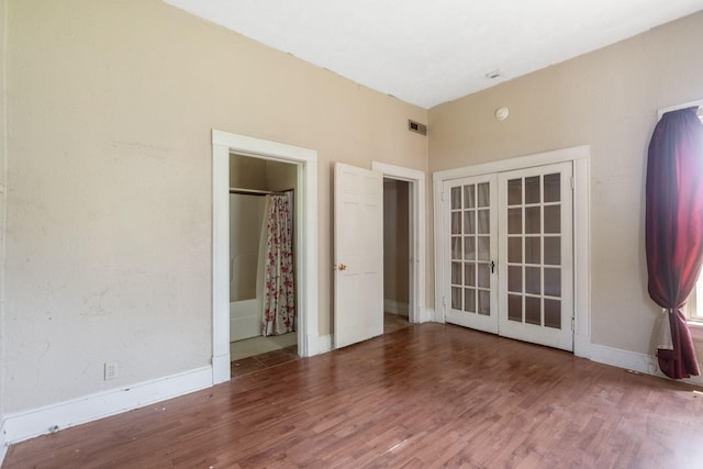 1123 W Hovey St, Springfield, MO 65802 - unfurnished bedroom featuring french doors and wood finished floors