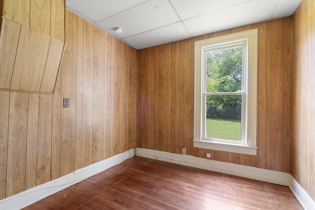 1123 W Hovey St, Springfield, MO 65802 - unfurnished room featuring healthy amount of natural light, wood finished floors, wooden walls, and a smoke detector