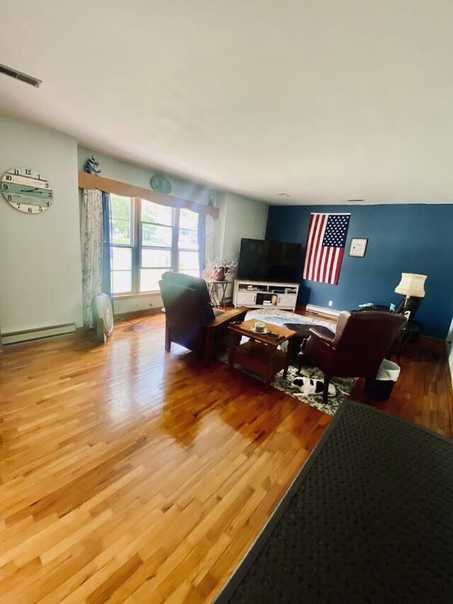 513 Meng St, Greenfield, MO 65661 - living area featuring wood finished floors and a baseboard radiator