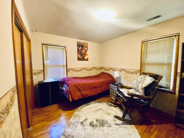 513 Meng St, Greenfield, MO 65661 - bedroom with wood finished floors, a closet, and a wainscoted wall
