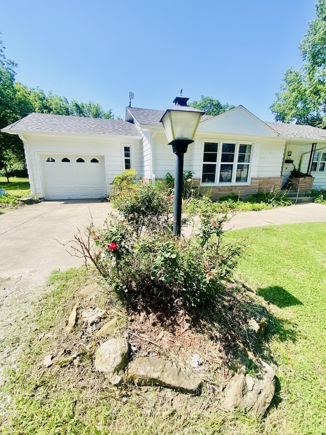 513 Meng St, Greenfield, MO 65661 - ranch-style house with concrete driveway, an attached garage, and a front lawn
