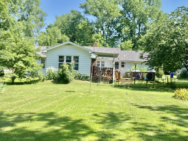 513 Meng St, Greenfield, MO 65661 - rear view of house featuring a deck, a yard, and a chimney