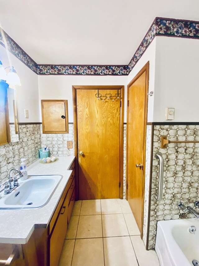 513 Meng St, Greenfield, MO 65661 - full bath with vanity, tile patterned floors, a wainscoted wall, a tub to relax in, and tile walls