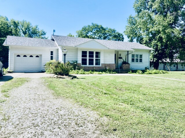 513 Meng St, Greenfield, MO 65661 - ranch-style home featuring driveway, an attached garage, and a front lawn