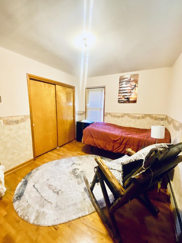 513 Meng St, Greenfield, MO 65661 - bedroom featuring a closet, wood finished floors, and a baseboard heating unit