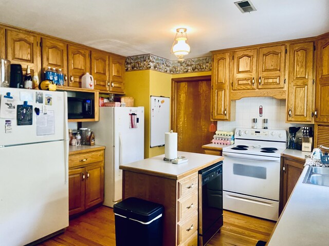 513 Meng St, Greenfield, MO 65661 - kitchen with black appliances, light countertops, brown cabinetry, and tasteful backsplash
