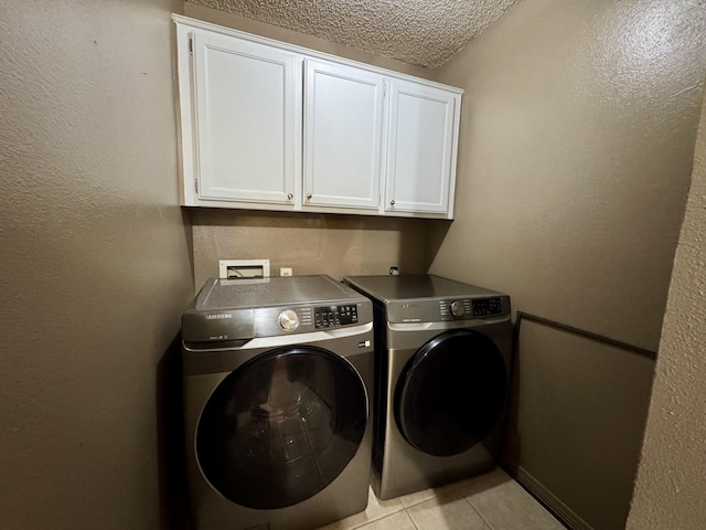 701 Barracuda Dr, Nixa, MO 65714 - laundry room with cabinet space, independent washer and dryer, light tile patterned floors, and a textured ceiling