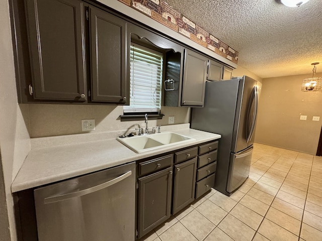 701 Barracuda Dr, Nixa, MO 65714 - kitchen featuring appliances with stainless steel finishes, a textured ceiling, light countertops, light tile patterned flooring, and decorative light fixtures