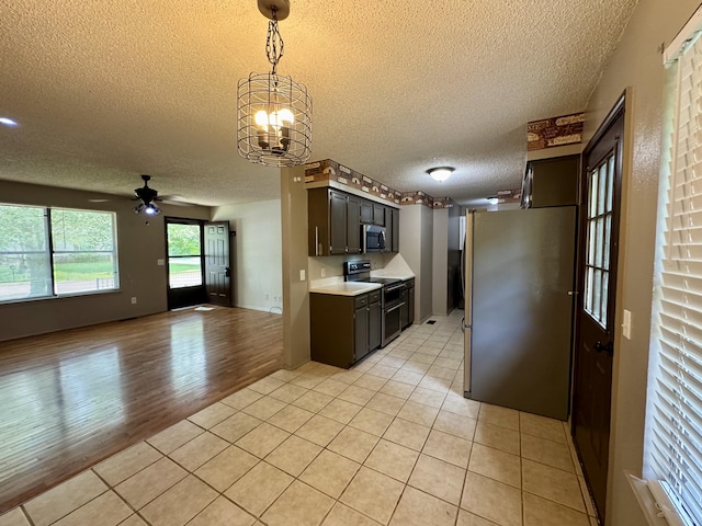 701 Barracuda Dr, Nixa, MO 65714 - kitchen featuring stainless steel appliances, a textured ceiling, light countertops, ceiling fan, and open floor plan