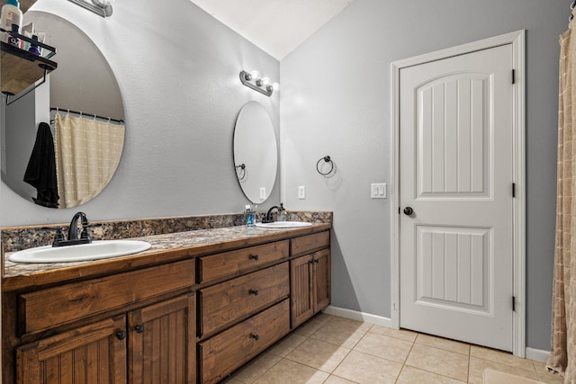 208 Dixie Ave, Clever, MO 65631 - bathroom with double vanity, tile patterned floors, and lofted ceiling