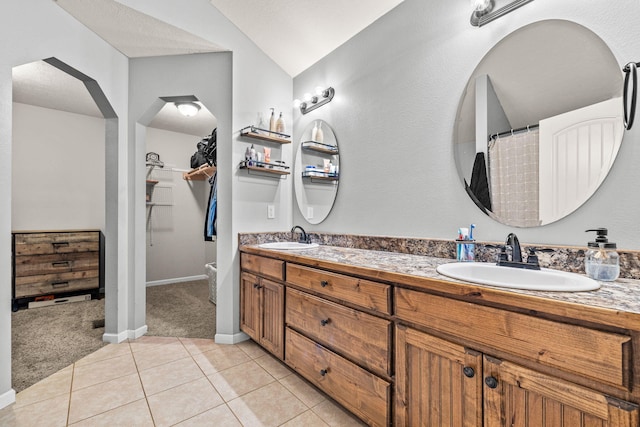 208 Dixie Ave, Clever, MO 65631 - bathroom featuring double vanity, tile patterned floors, vaulted ceiling, and a walk in closet