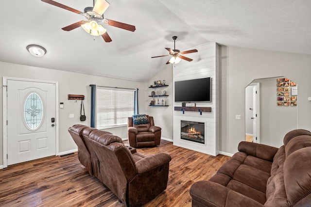 208 Dixie Ave, Clever, MO 65631 - living room with lofted ceiling, ceiling fan, wood finished floors, a fireplace, and arched walkways