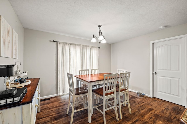 208 Dixie Ave, Clever, MO 65631 - dining room featuring dark wood-style flooring, a chandelier, and a textured ceiling