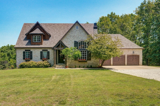 7607 N Angler Ln, Strafford, MO 65757 - view of front facade featuring driveway, stone siding, a front yard, a garage, and a chimney