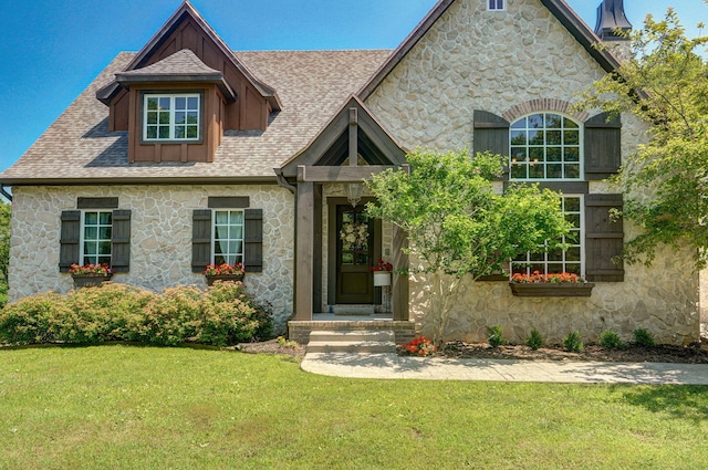 7607 N Angler Ln, Strafford, MO 65757 - view of front facade with stone siding, a front lawn, and a shingled roof