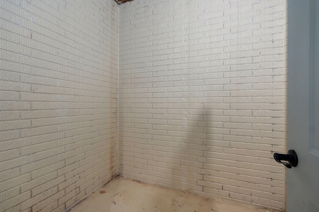 7607 N Angler Ln, Strafford, MO 65757 - spare room featuring concrete flooring and brick wall