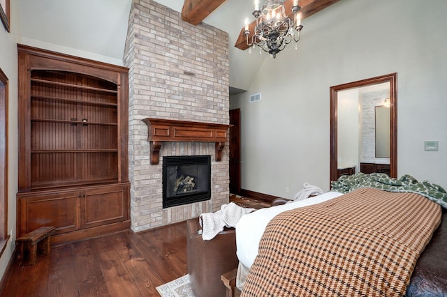 7607 N Angler Ln, Strafford, MO 65757 - bedroom with a fireplace, a chandelier, dark wood-style floors, beamed ceiling, and high vaulted ceiling
