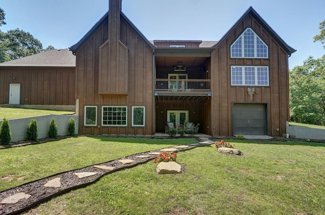 7607 N Angler Ln, Strafford, MO 65757 - rear view of house featuring board and batten siding, an attached garage, and a yard