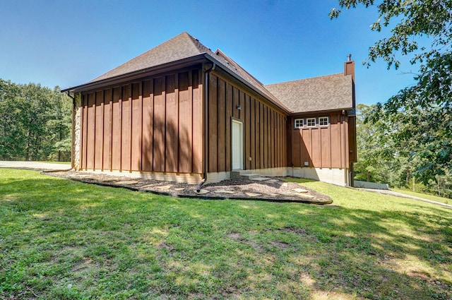 7607 N Angler Ln, Strafford, MO 65757 - view of side of property with board and batten siding, a yard, a chimney, and roof with shingles