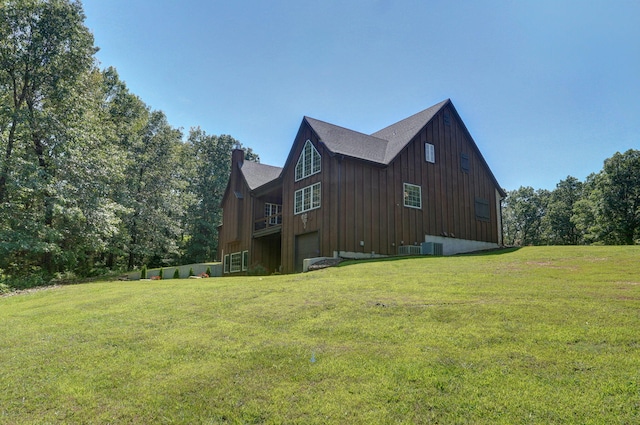 7607 N Angler Ln, Strafford, MO 65757 - view of home's exterior featuring an attached garage, a yard, board and batten siding, and a chimney