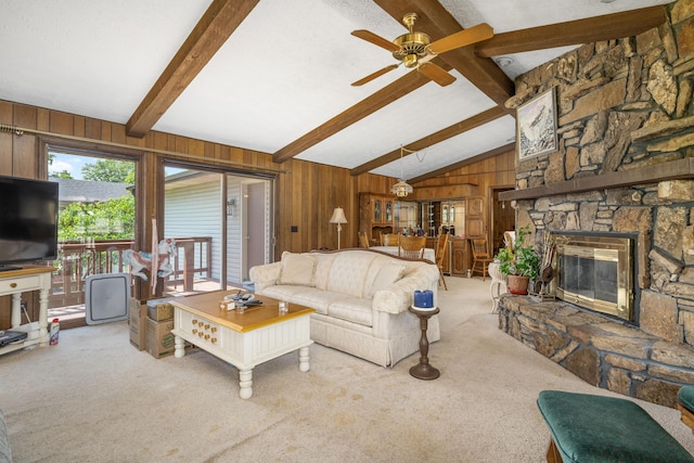 26307 Twin Rivers Dr, Shell Knob, MO 65747 - carpeted living area with wooden walls, a ceiling fan, and a stone fireplace