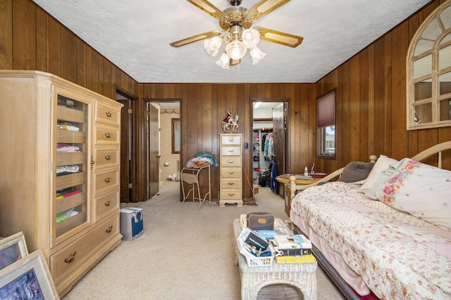 26307 Twin Rivers Dr, Shell Knob, MO 65747 - bedroom with carpet floors, wooden walls, a spacious closet, a closet, and a textured ceiling