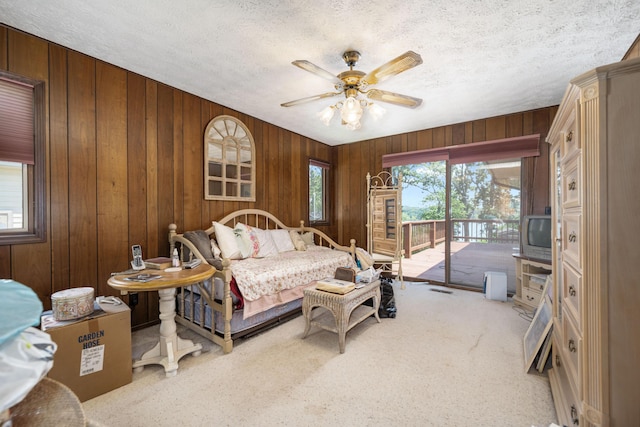 26307 Twin Rivers Dr, Shell Knob, MO 65747 - bedroom with access to outside, multiple windows, wooden walls, carpet flooring, and a textured ceiling