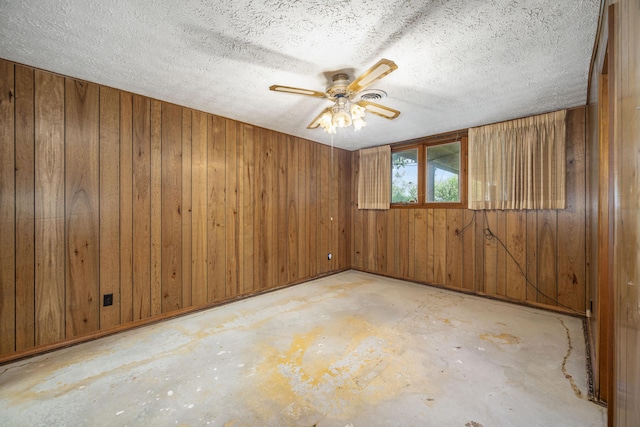 26307 Twin Rivers Dr, Shell Knob, MO 65747 - empty room featuring concrete floors, wood walls, and ceiling fan