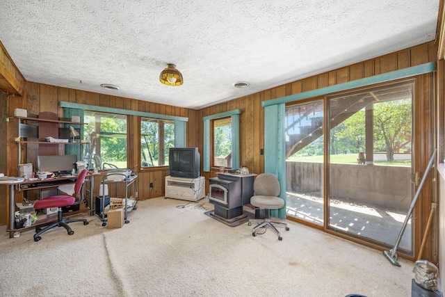 26307 Twin Rivers Dr, Shell Knob, MO 65747 - carpeted office featuring a wood stove, wood walls, and a textured ceiling