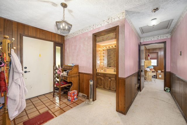 26307 Twin Rivers Dr, Shell Knob, MO 65747 - entryway featuring wooden walls, a textured ceiling, and wainscoting