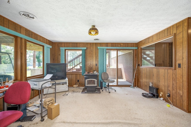 26307 Twin Rivers Dr, Shell Knob, MO 65747 - carpeted office featuring wood walls, a wood stove, and a textured ceiling