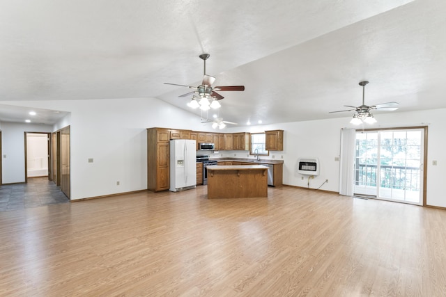 29474 Farm Rd Unit 1260, Golden, MO 65658 - kitchen featuring stainless steel appliances, heating unit, ceiling fan, open floor plan, and vaulted ceiling
