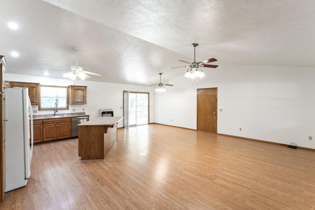 29474 Farm Rd Unit 1260, Golden, MO 65658 - kitchen featuring freestanding refrigerator, dishwasher, a ceiling fan, lofted ceiling, and brown cabinets