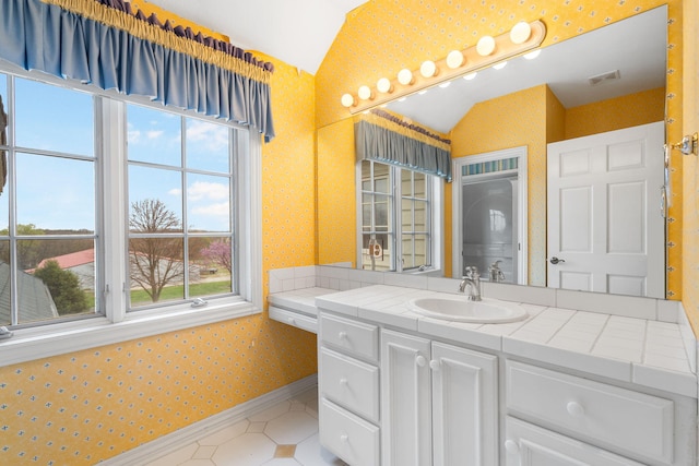 4156 E Division St, Springfield, MO 65802 - bathroom with wallpapered walls, lofted ceiling, vanity, and tile patterned flooring