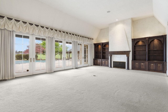 4156 E Division St, Springfield, MO 65802 - unfurnished living room with french doors, a large fireplace, high vaulted ceiling, and carpet floors
