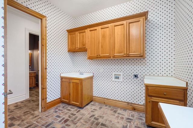 4156 E Division St, Springfield, MO 65802 - laundry room featuring wallpapered walls, cabinet space, hookup for an electric dryer, washer hookup, and brick patterned floors