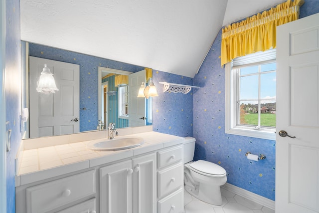 4156 E Division St, Springfield, MO 65802 - bathroom featuring lofted ceiling, wallpapered walls, vanity, and tile patterned flooring