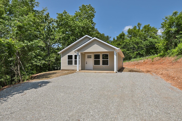 302 E College St, Crane, MO 65633 - view of front facade featuring driveway and covered porch