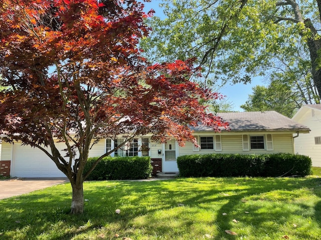 2716 E Linwood St, Springfield, MO 65804 - view of property hidden behind natural elements featuring a front yard, a garage, concrete driveway, brick siding, and a shingled roof