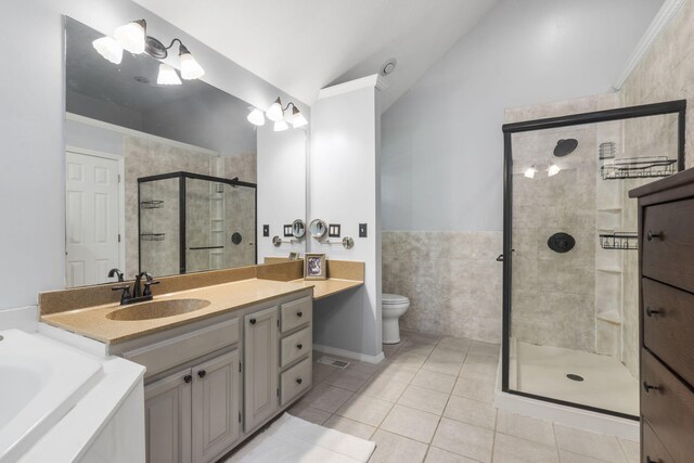 2504 W Fox Fire Ct, Nixa, MO 65714 - bathroom with vaulted ceiling, tile patterned floors, vanity, a shower stall, and a garden tub
