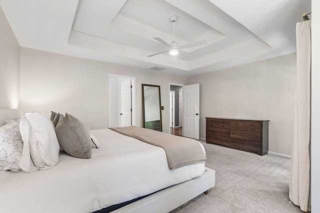 2504 W Fox Fire Ct, Nixa, MO 65714 - bedroom with a tray ceiling, light carpet, and a ceiling fan