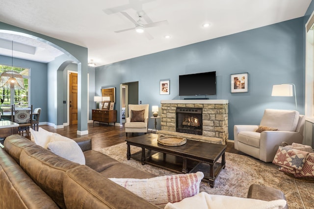 2504 W Fox Fire Ct, Nixa, MO 65714 - living area with wood finished floors, arched walkways, ceiling fan, a stone fireplace, and recessed lighting