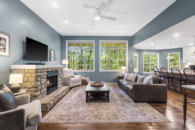 2504 W Fox Fire Ct, Nixa, MO 65714 - living room featuring hardwood / wood-style flooring, ceiling fan, a stone fireplace, and recessed lighting